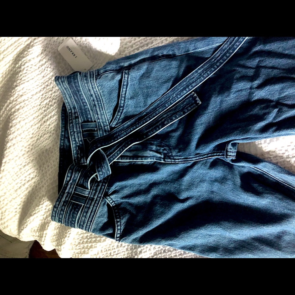 Denim flare jeans with buttons and tie belt.